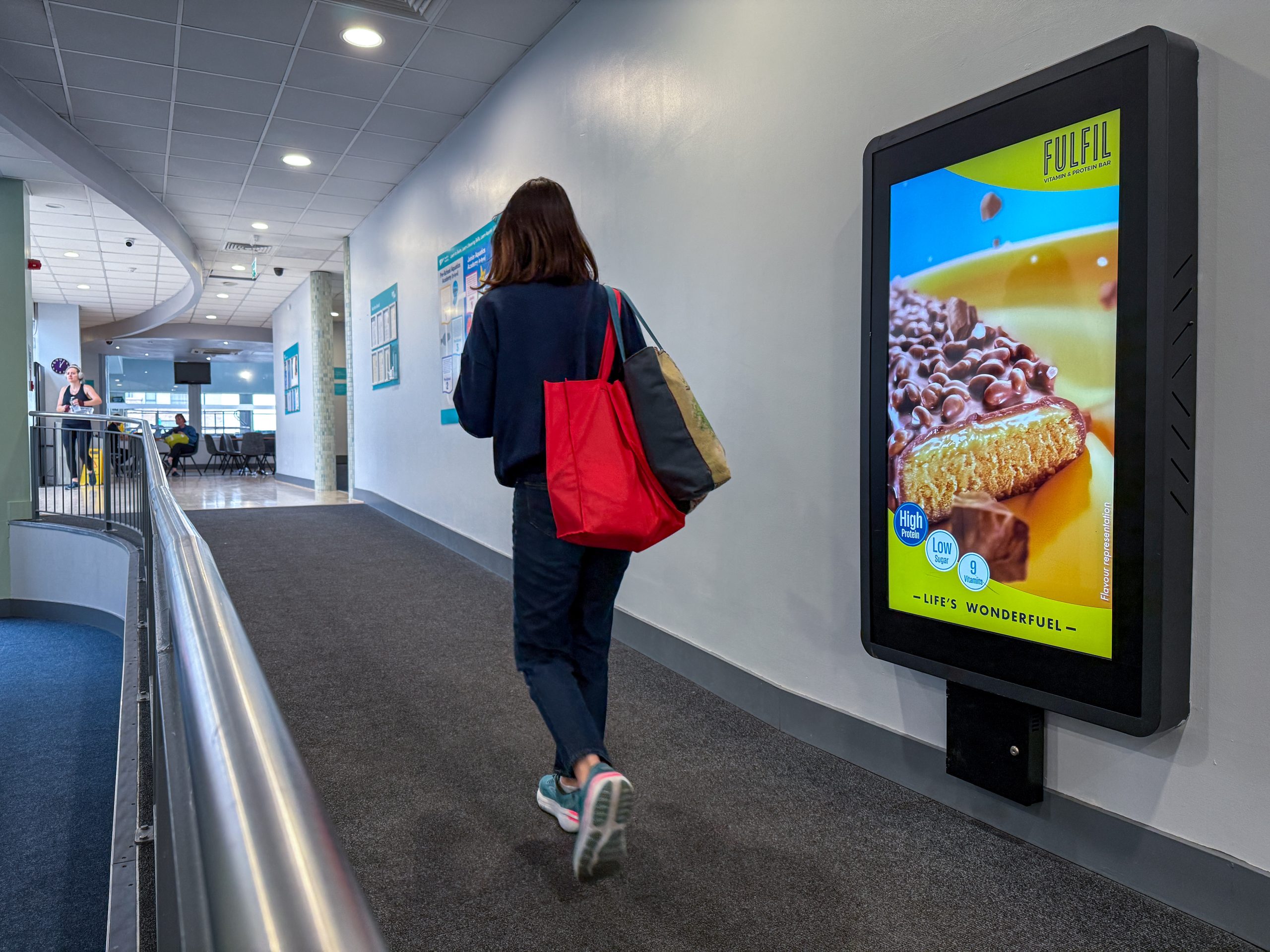 Woman walking past screen